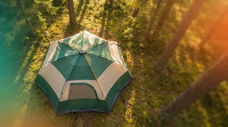 Tent fast pitch system guide showing color-coded hub and poles being set up at forest campsite
