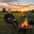 David King sitting by a campfire at sunset